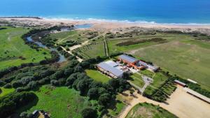 an aerial view of a house and a river at Trafalgar Polo Club in El Palmar