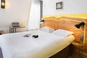 Postel nebo postele na pokoji v ubytování ibis Styles Paris Nation Porte De Montreuil