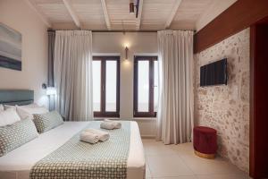 Posteľ alebo postele v izbe v ubytovaní Philikon Luxury Suites