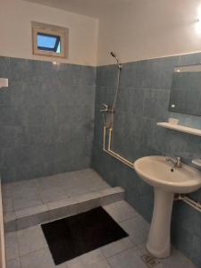 a bathroom with a sink and a toilet and a shower at Casa Elenisse in 2 Mai +5 photos