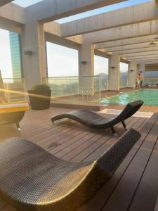 a chair on the floor of a building with a pool at Las Condes De Lujo in Santiago