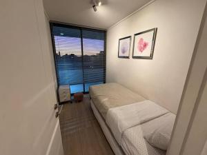 a small bedroom with a bed and a window at Las Condes De Lujo in Santiago +22 photos