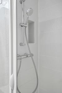 a shower with a shower head in a bathroom at Casa Enna in Rueil-Malmaison
