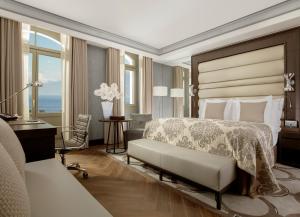 a hotel room with a bed and a desk and a bedroom at Royal Savoy Hotel & Spa in Lausanne