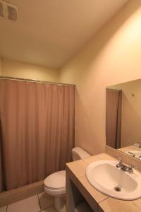 a bathroom with a sink and a toilet and a shower at Plaza Magdalena Hotel in Copan Ruinas