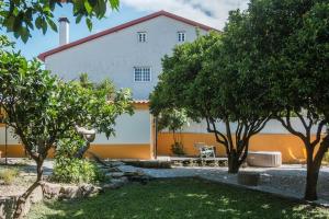 a white house with trees in front of it at BABhouse Villa Jardim das Laranjeiras in Nagoselo do Douro