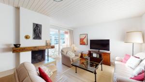 a living room with a couch and a fireplace at Apartment Skyline 307 in St. Moritz
