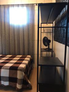 a bedroom with a bunk bed and a window at Casa da vila in Imbituba