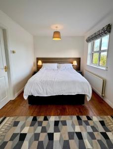 a bedroom with a large bed and a window at Lawnfield Lodge in Newcastle