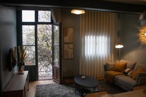 a living room with a couch and a window at Brasilia Residences in Guimarães