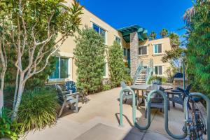 a patio with a table and chairs and trees at OB Pier Paradise in San Diego