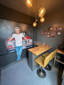 a room with a painting of a man in a fire truck at Muse- Morgan Wallen Speakeasy and Giant Balcony in Nashville