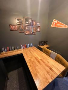 a wooden table in a room with books on the wall at Muse- Morgan Wallen Speakeasy and Giant Balcony in Nashville