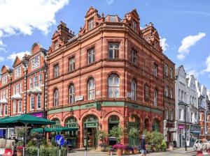 a large red brick building on a city street at City Life Access Everywhere in London