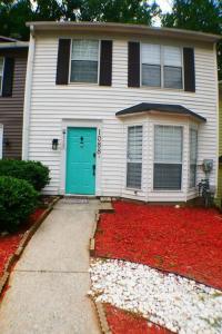 a house with a green door and a lot of red leaves at The Trace Elegant Eclectic Home with patio in Smyrna Ga in Smyrna