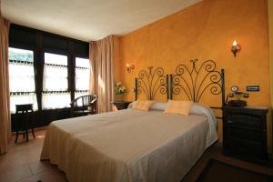 a bedroom with a large bed in a room at Posada-Spa Privilegio de Vara in Noja +29 photos