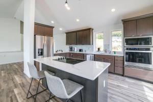 a kitchen with a large island with white counter tops at Deck with Lake Barkley Views Spacious Family Home! in Eddyville