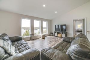 a living room with a couch and a television at Deck with Lake Barkley Views Spacious Family Home! in Eddyville