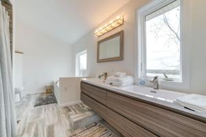 a bathroom with a large sink and a window at Deck with Lake Barkley Views Spacious Family Home! in Eddyville +25 photos