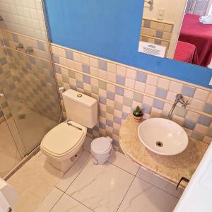 a bathroom with a toilet and a sink at Porto Mar de Búzios in Búzios