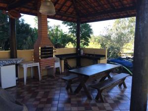 a outdoor kitchen with a table and a stove at Pousada Sarapui in Sarapuí