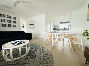 a living room with a couch and a table at 2-Bedroom Charm near Mater Hospital Pimlico in Aitkenvale