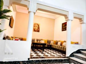 a living room with a couch and a checkered floor at Riad Izza in Marrakesh