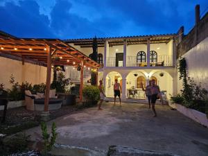 a group of people standing outside of a house at Blue Moon Hostel in Antigua Guatemala