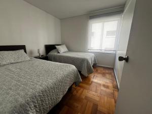 Ένα ή περισσότερα κρεβάτια σε δωμάτιο στο Disfruta la tranquilidad frente al mar