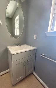 a bathroom with a sink and a mirror at 10412 Beaver knoll Dr in Upper Marlboro