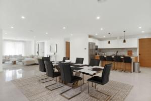 a dining room and kitchen with a table and chairs at Inlet Paradise in Rhyll