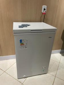 a white refrigerator with a counter on top of it at Apartamento Frente para o mar in Ilha Comprida