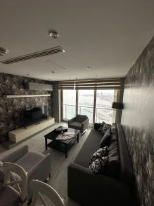 A seating area at Ottomare Suites luxury apartment with pool with amazing view