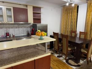 a kitchen with a table with a bowl of fruit on it at City Square Apartment 1st floor in Strumica +4 photos