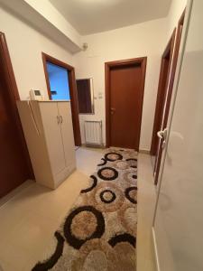 a room with a carpet on the floor and a door at City Square Apartment 1st floor in Strumica