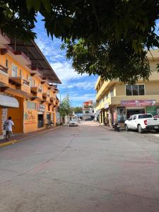 an empty street in a town with buildings at Lolitas Suites 303 in Zihuatanejo
