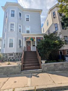 a house with a staircase leading to the front door at Boston Homestel in Boston