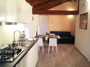 een keuken en woonkamer met een tafel en een bank bij Musicasa Vacanza in Muscletto