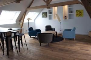 a room with chairs and a table in a attic at Tillac Chambres d'hôtes in Pléchâtel