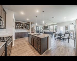a large kitchen and dining room with a table and chairs at The in Crowley