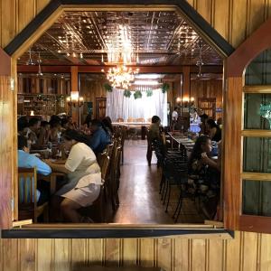 a group of people sitting at tables in a restaurant at Tropical Magnolia in Hellgate +26 photos