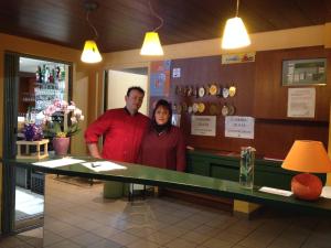 a man and a woman standing in front of a counter at Le Pavillon in Cours la Ville +74 photos