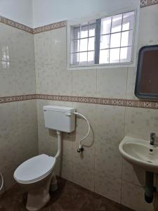 a bathroom with a toilet and a sink at White House Homestay in Cochin