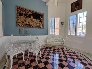 a room with a table and chairs and a painting at Departamentos Olga in Progreso +28 photos