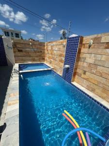 a swimming pool with two lawn chairs in it at Flat Rainha da Serra in Bezerros +15 photos