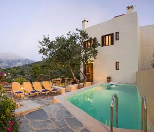 a villa with a swimming pool and a house at Amari Villas in Amárion