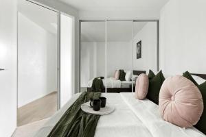 a living room with a couch and a table at Stylish 2BR Apartment with Panoramic City Views in Melbourne +19 photos