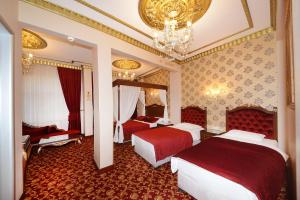 A bed or beds in a room at Hotel Grand Umit Még 37 kép