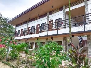 a building with balconies and plants in front of it at Elsa's beach house in Itaytay