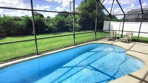 a swimming pool in a house with a view of a yard at Safari Lodge in Orlando